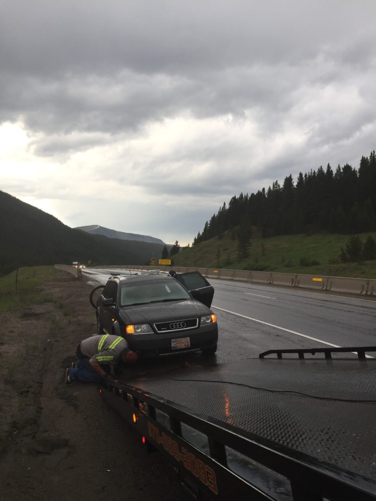 Black Audi Allroad getting pulled onto the tow truck