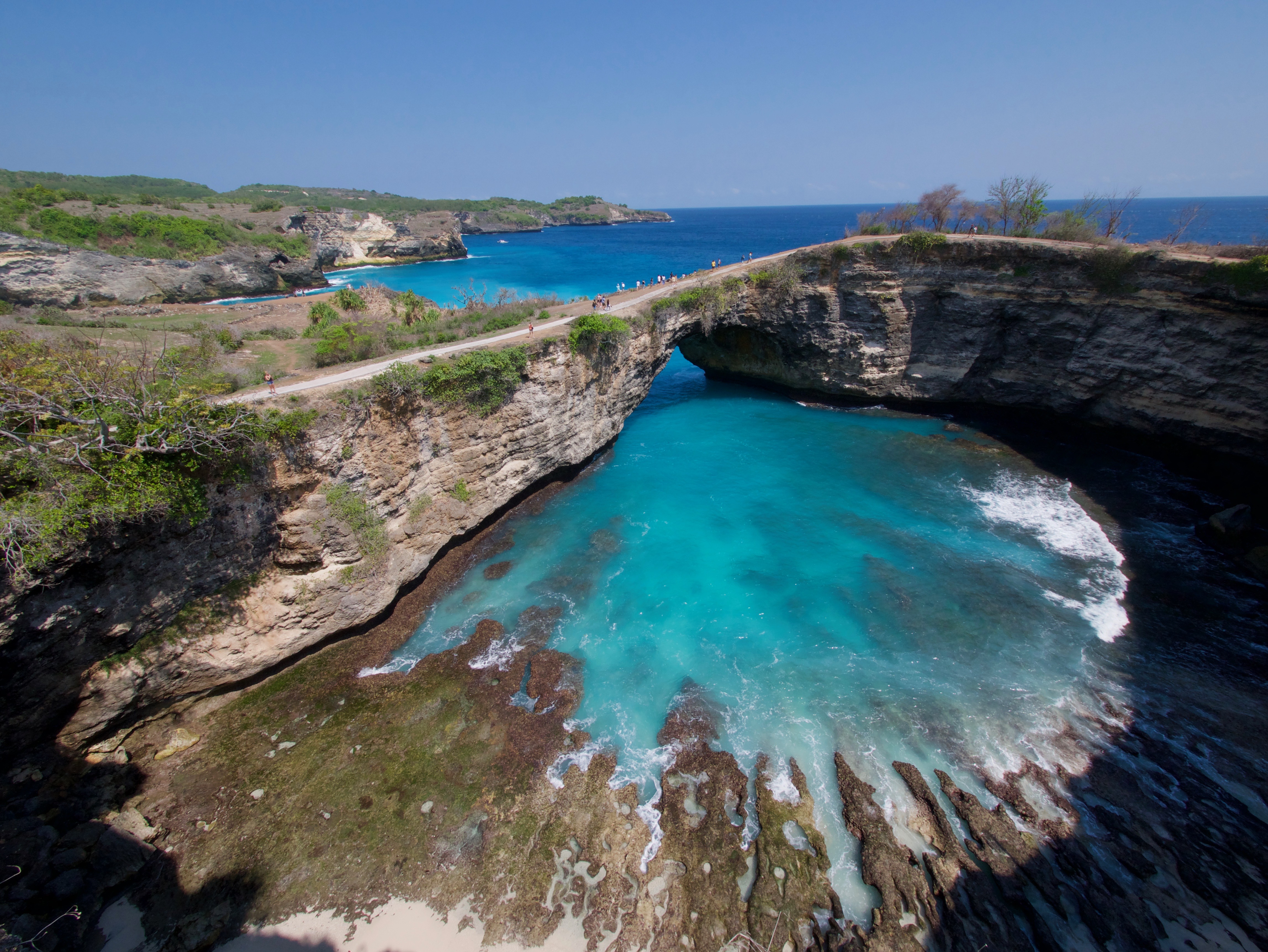 Turquoise waters crashing through a stone arch at Broken Beach in Nusa Penida, Bali, Indonesia